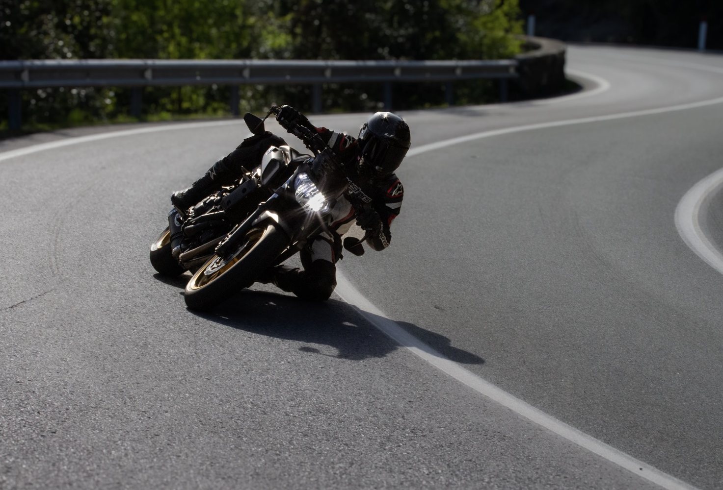 Moto naked in piega in un tornante